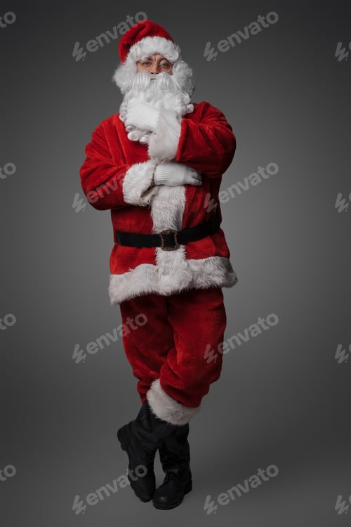 Preview: Christmas santa stroking his beard against gray background