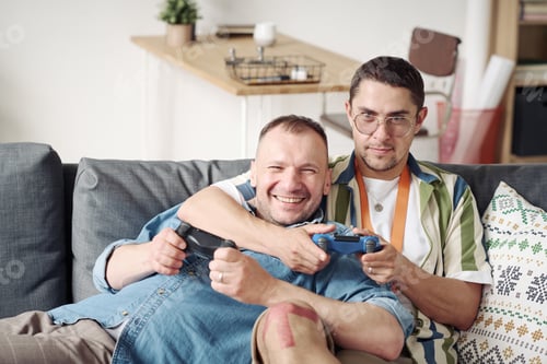 Preview: Gay couple playing game console
