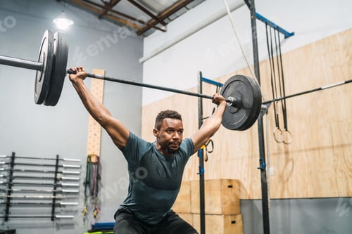 Preview: Crossfit athlete doing exercise with a barbell.