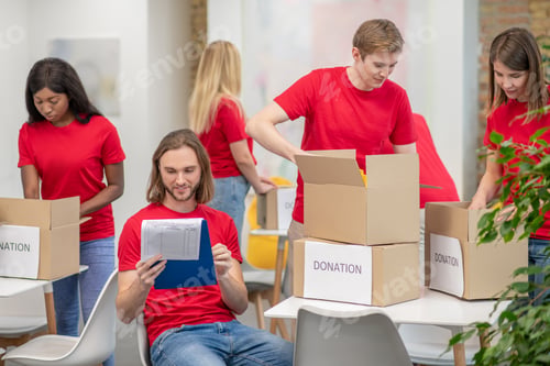 Preview: Volunteers working in a sorting point and looking busy