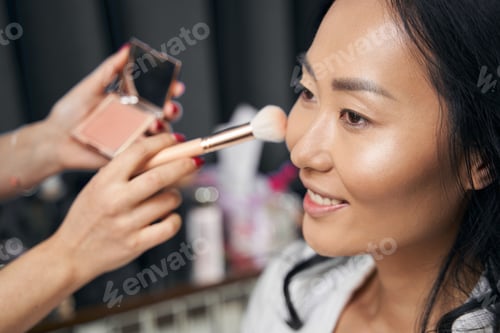 Preview: Young elegant lady is getting visage with luxury cosmetics in beauty space