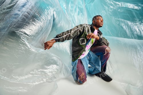Preview: Young afroamerican model in outwear jacket with led stripes and ripped jeans
