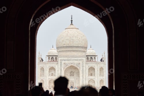 Preview: Archway of main gateway in Taj Mahal entrance with tourists silhouettes, view to Taj Mahal mausoleum