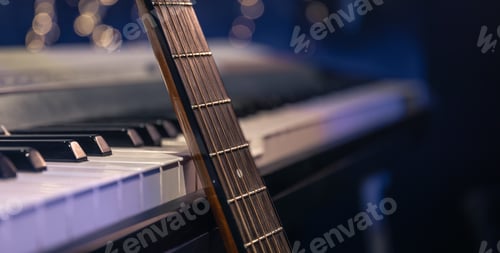 Preview: Guitar and piano keys close-up on a blurred background with bokeh.