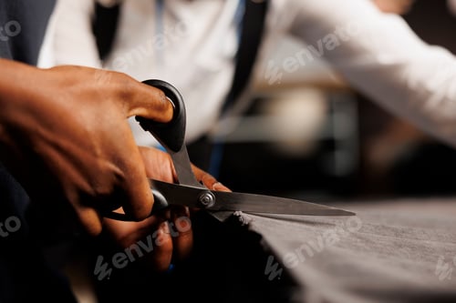 Preview: Close up of couturier using scissors