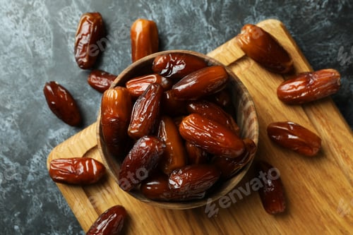 Preview: Board with bowl of dried dates on black smokey background