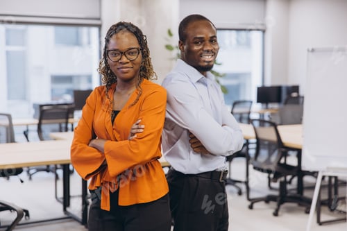 Preview: African american corporate colleagues standing back to back, representing professional teamwork