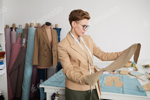 Preview: Tailor examining the fabric