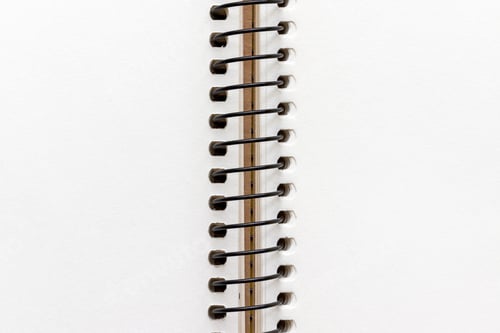 Preview: Open spiral notebook with blank empty white sheets, closeup top view, paper background