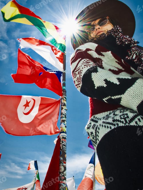 Preview: Low angle shot of a young girl standing by the flags