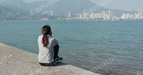 Preview: Woman sit on the jetty pier