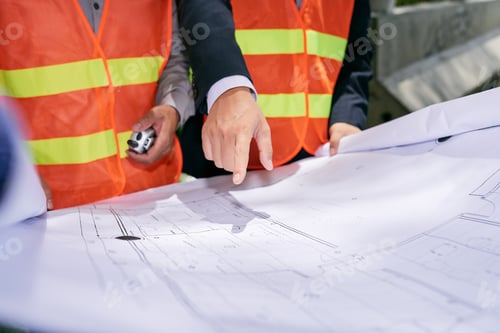 Construction Workers Reviewing Plans at a Construction Site