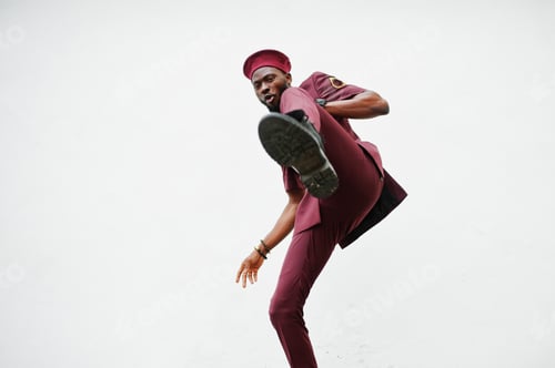 Preview: Kick by leg. Portrait of African American military man in red uniform and beret.
