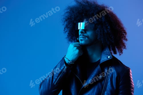 Preview: Portrait of fashion man with curly hair with stylish glasses on blue background multinational