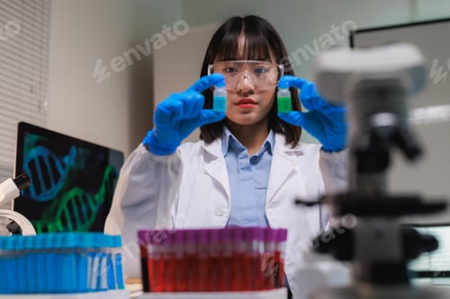 Preview: Female scientist comparing chemical samples in laboratory researching genomics