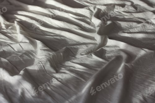 Preview: crumpled white sheets, empty bed sheet