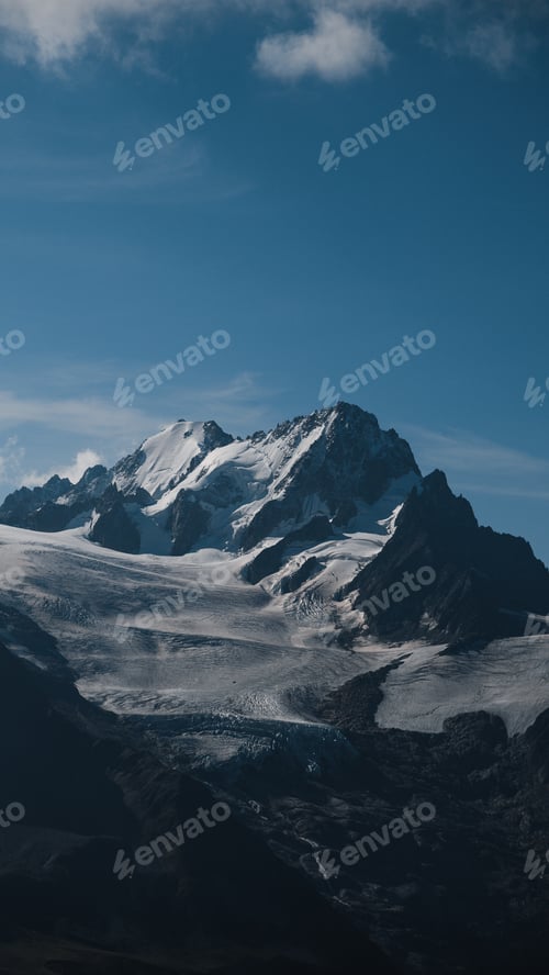 Preview: Snow-covered peaks of the Aiguille de Argentière rising over glaciers in the French Alps