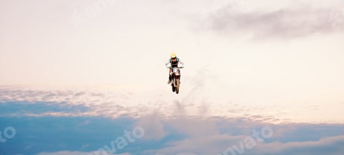 Preview: Motorcycle, blue sky and jump for training or sports with fitness, balance or challenge in nature o