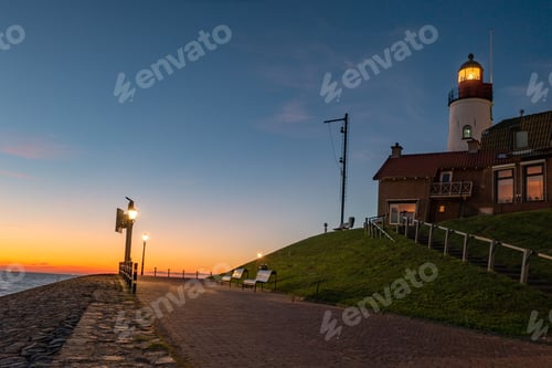 Preview: Urk Flevoland Netherlands sunset at the lighthouse and harbor of Urk Holland