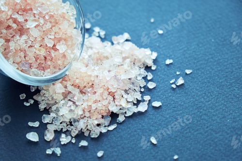 Preview: bowl of pink himalayan salt on dark table, top view, copy space