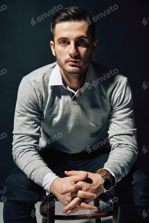 Preview: Confident handsome man portrait on dark background