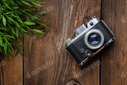 Preview: Vintage camera on wooden background.
