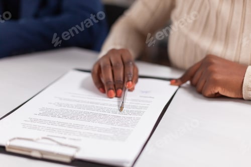 Preview: African businesswoman reading signing documents