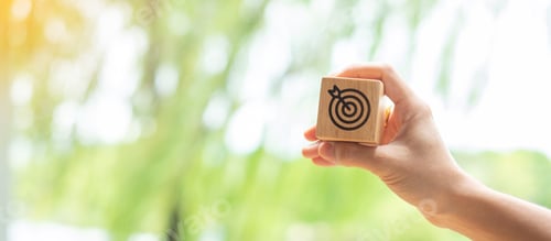 Preview: hand hold dartboard block with business goal, strategy