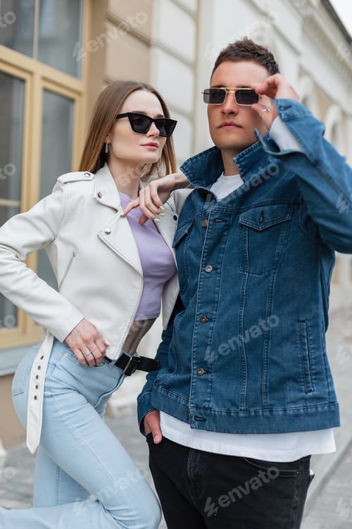 Preview: Beautiful couple in love in fashion denim clothes walking in the city