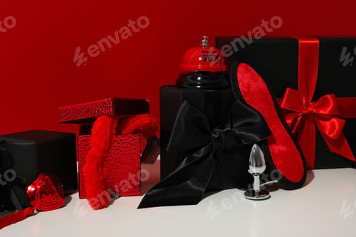 Preview: A collection of sex toys on a red background.