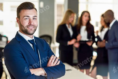 Preview: Businessman leader in modern office with businesspeople working