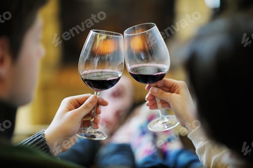 Preview: Happy Young Romantic Couple Sitting On Sofa In Front Of Fireplace At Winter Season In Home