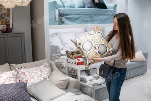 Preview: Customer woman buying new furniture - sofa or couch in a store