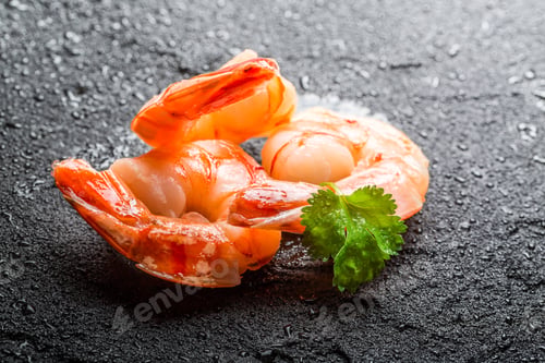 Preview: Shrimps served on a black rock