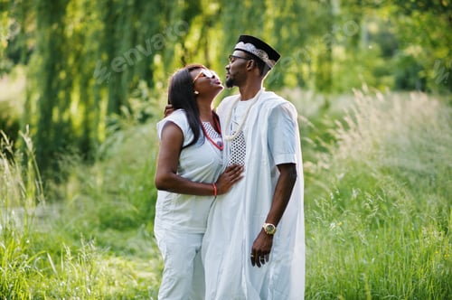 Preview: Black african couple in love kissing at green park on sunset