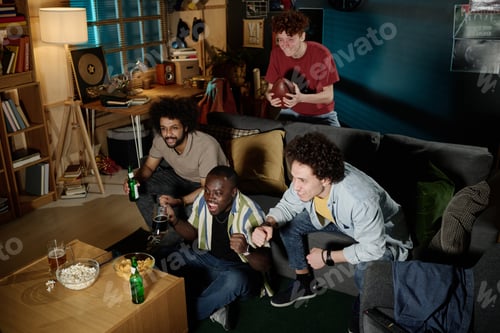 Preview: Young Men Watching Football Match At Night