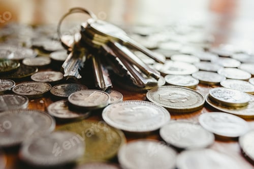 Preview: House keys on pile of old Spanish coins