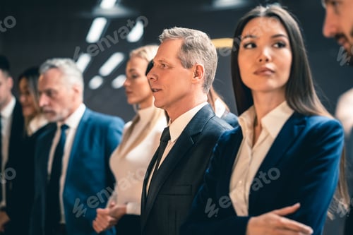 Preview: The five businesspeople standing indoor.