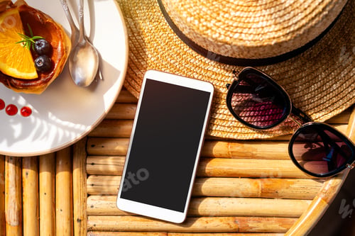 Preview: Empty screen smart phone with travel accessories on wooden table, Summer vacation concept