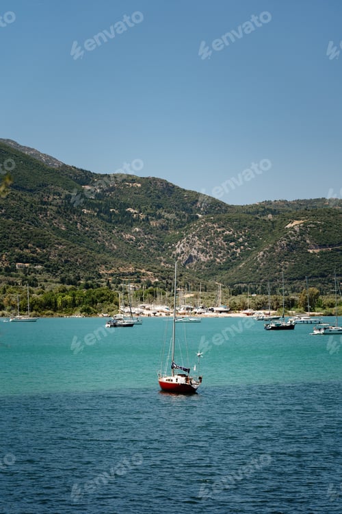 Preview: Solitary Sailboat on a Crystal Blue Bay