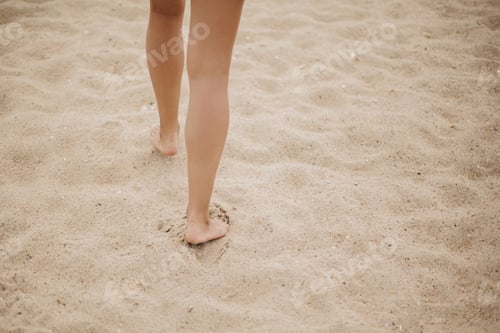 Preview: Beautiful woman legs barefoot walking on sandy beach, carefree vacation mood. Summer beach