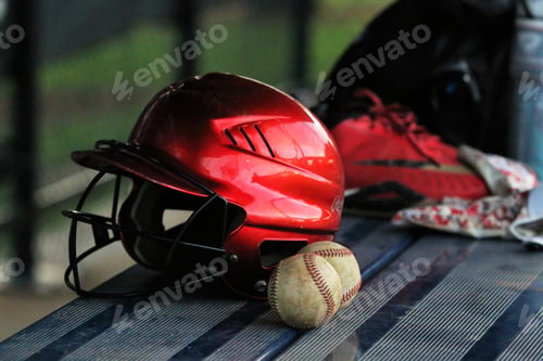 Preview: Closeup of baseball helmet and baseball balls on a dugout bench