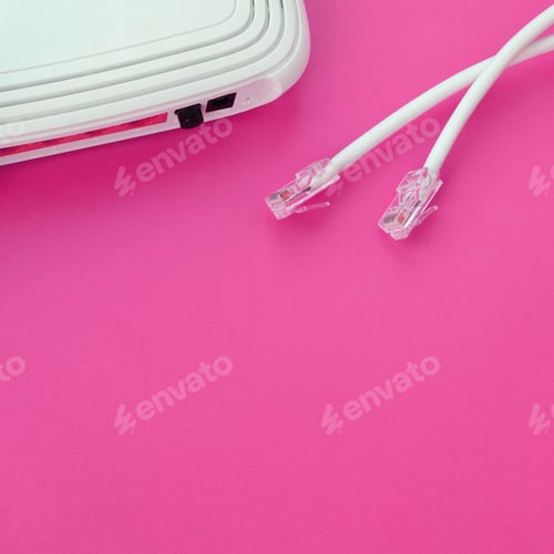 Preview: Internet router and Internet cable plugs lie on a bright pink background