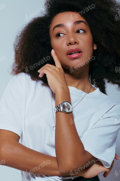 Preview: good looking african american trendsetter in elegant attire with curly hair looking away, fashion