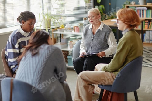 Preview: Middle Aged Caucasian Woman Leading Group Therapy Session with Diverse Adults