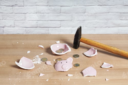 Preview: broken Piggy bank smashed into pieces with hammer and small change