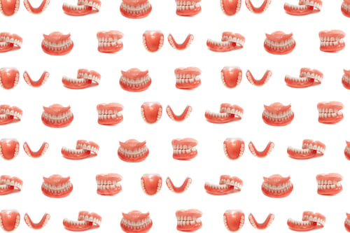 Preview: Set of dentures on a white background. Full removable plastic denture of the jaws
