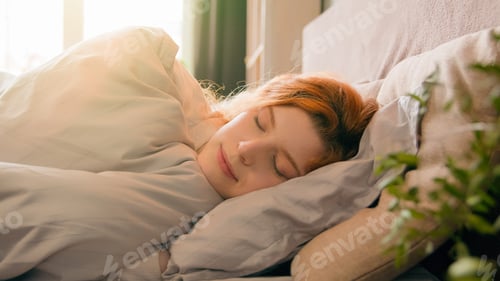 Preview: Sleepy beautiful woman waking up lying in comfortable white bed smiling toothy happy smile carefree