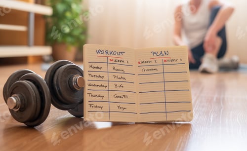 Preview: Planning home workout routine with dumbbells for fitness wellness
