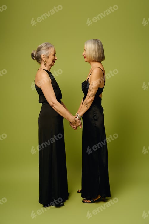 Preview: A mature lesbian couple shares a tender moment, celebrating love against a vibrant backdrop